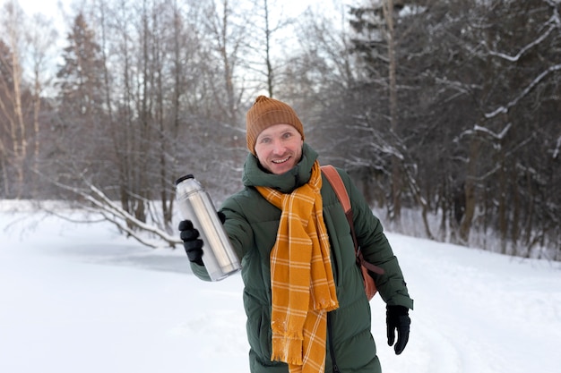 Medium shot smiley man holding flask