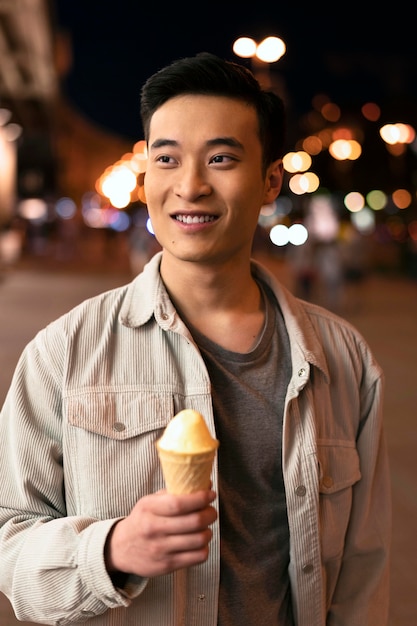 Medium shot smiley man holding ice cream