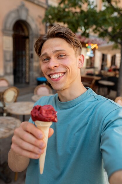 Medium shot smiley man holding ice cream