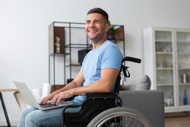 Medium shot smiley man holding laptop