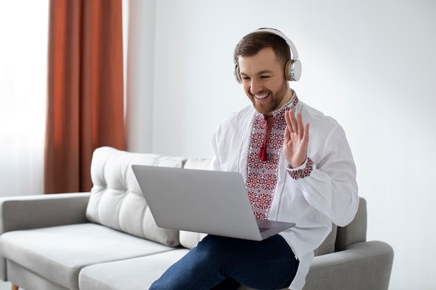 Medium shot smiley man holding laptop