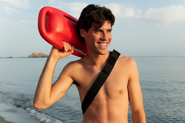 Free photo medium shot smiley man holding lifesaving buoy