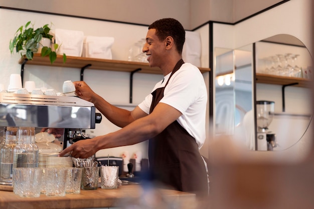 Medium shot smiley man making coffee