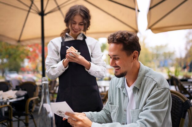 Medium shot smiley man at restaurant