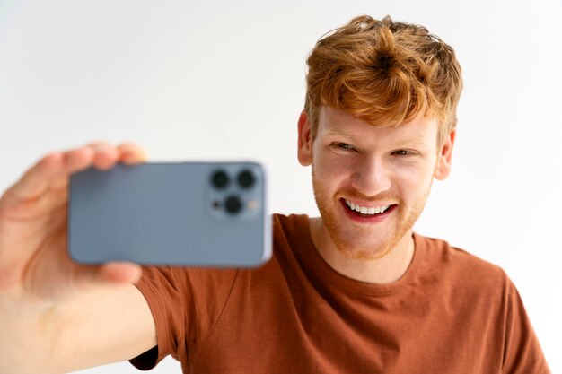 Medium shot smiley man taking selfie