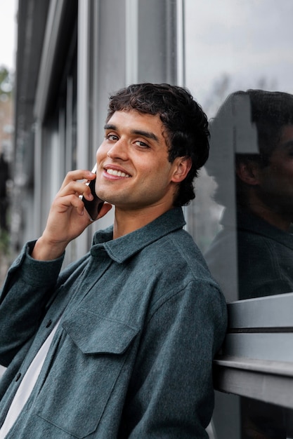 Medium shot smiley man talking on phone