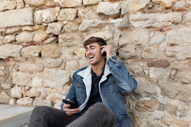 Medium shot smiley man wearing headphones