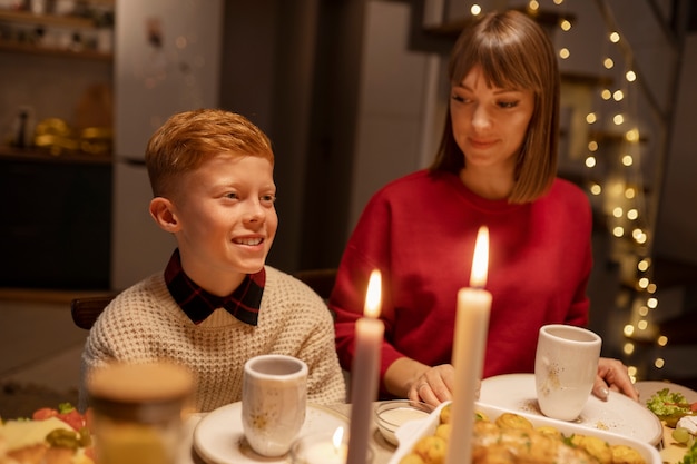 Free photo medium shot smiley mother and kid at table