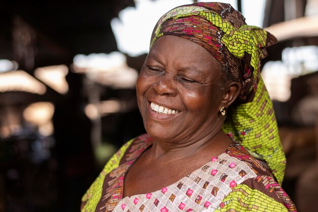 Medium shot smiley old woman outdoors