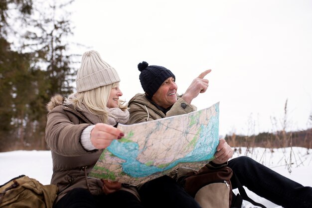 Medium shot smiley people holding map