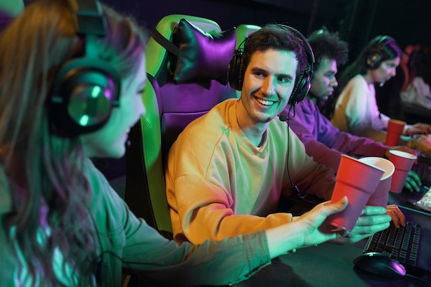 Medium shot smiley people playing videogame