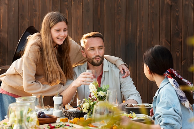 Free photo medium shot smiley people sitting at table