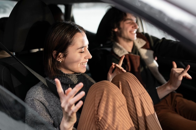 Medium shot smiley people traveling by car