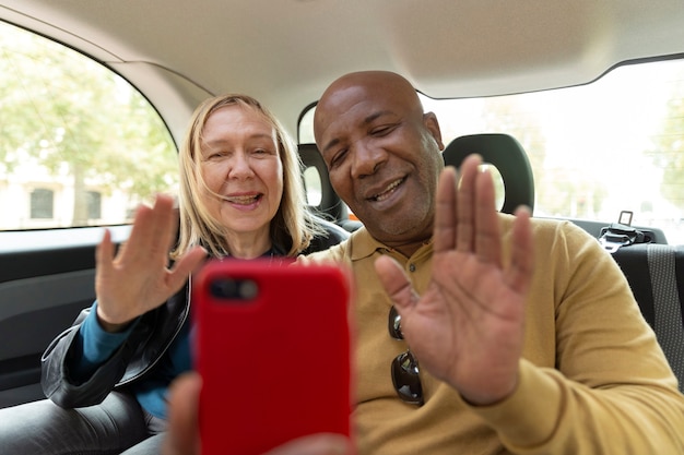 Medium shot smiley people with smartphone