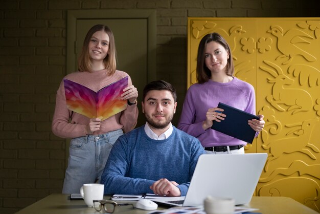 Medium shot smiley people working at office