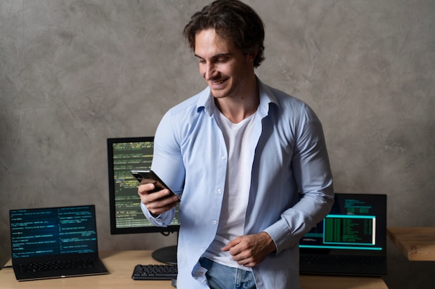 Medium shot smiley programmer holding phone