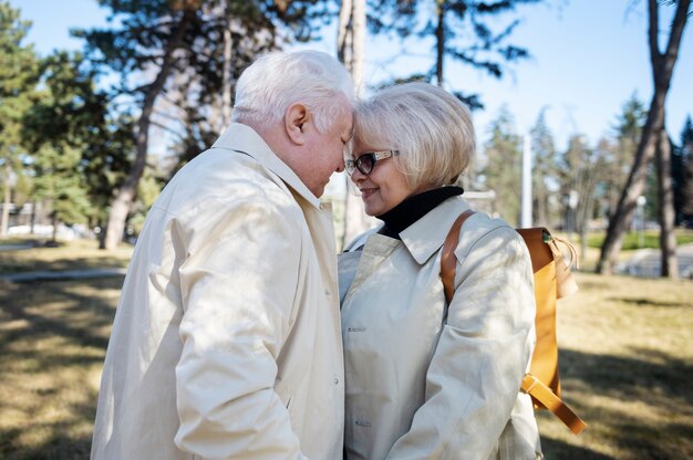 Medium shot smiley senior people outdoors