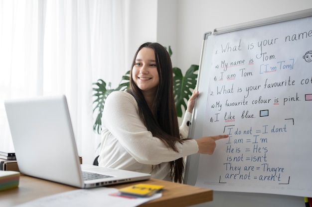 Medium shot smiley teacher explaining