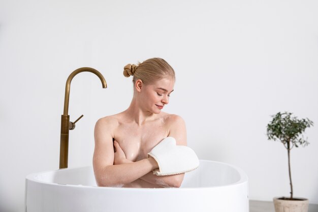 Medium shot smiley woman in bathtub