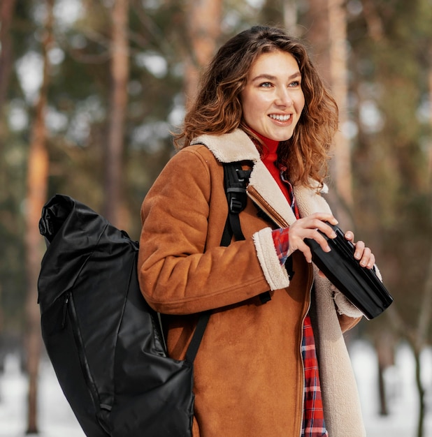 Free Photo medium shot smiley woman carrying backpack