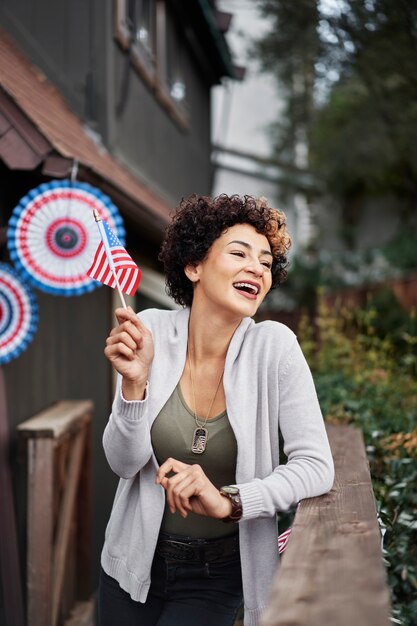 Medium shot smiley woman celebrating outside