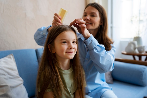 Free photo medium shot smiley woman combing hair