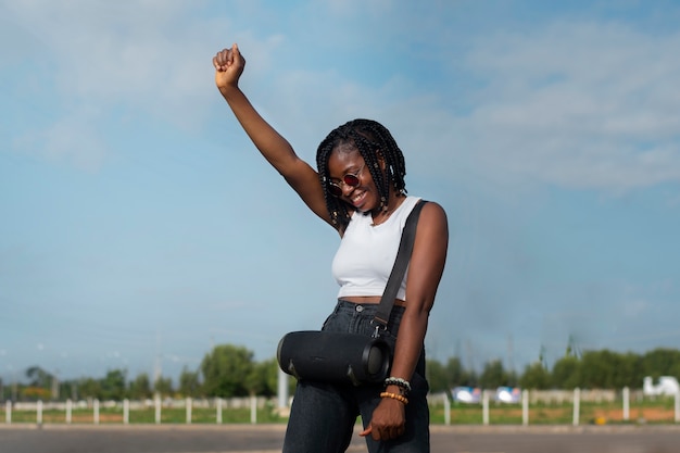 Medium shot smiley woman dancing outdoors