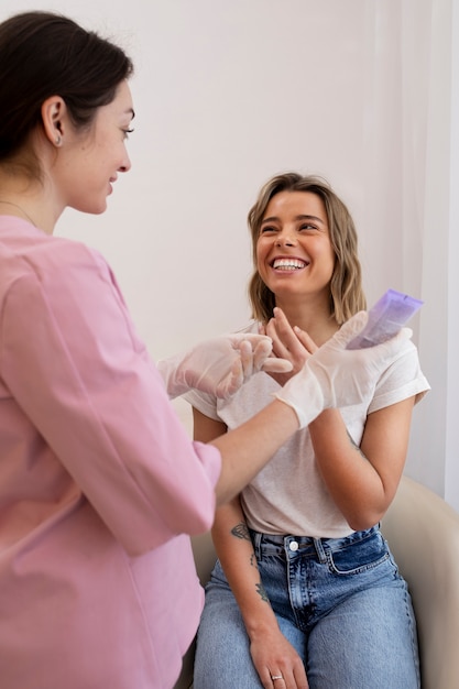 Medium shot smiley woman getting lip filler