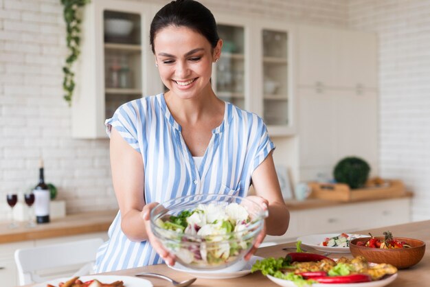 Medium shot smiley woman holding bowl