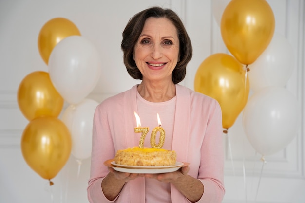 Medium shot smiley woman holding cake