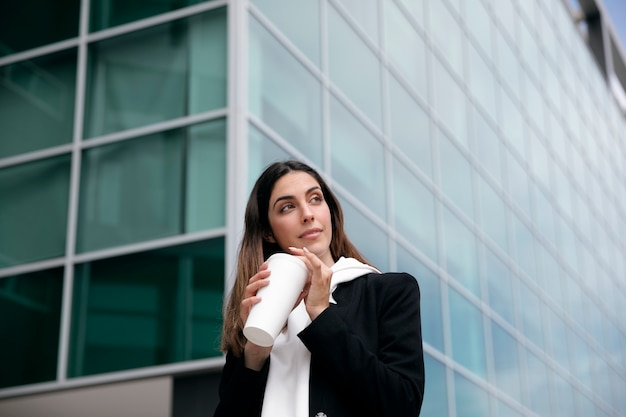 Medium shot smiley woman holding coffee cup