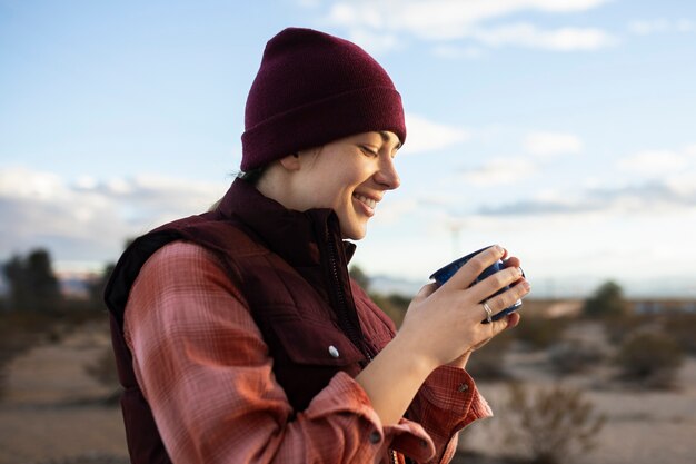 Medium shot smiley woman holding cup