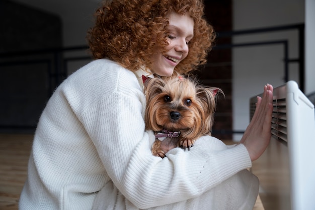 Free Photo medium shot smiley woman holding cute dog