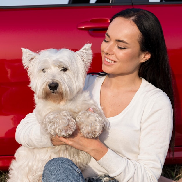 Medium shot smiley woman holding dog