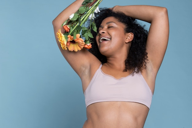 Medium shot smiley woman holding flowers