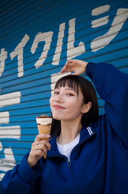 Free photo medium shot smiley woman holding ice cream cone