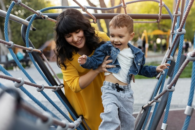 Free photo medium shot smiley woman holding kid