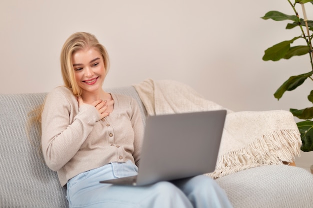 Medium shot smiley woman holding laptop