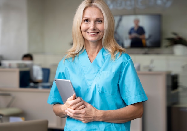 Medium shot smiley woman holding tablet