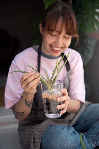 Medium shot smiley woman holding water glass