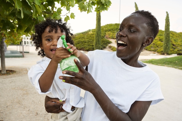 Medium shot smiley woman and kid