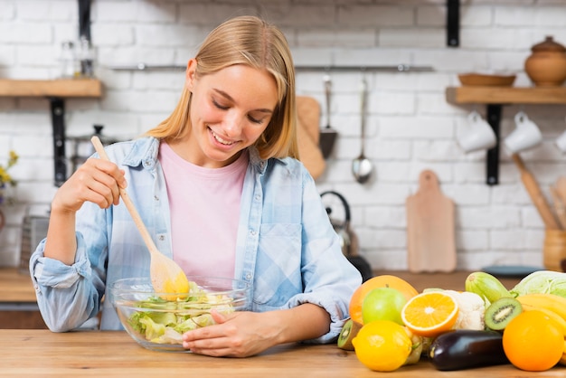 Medium shot smiley woman making healthy food