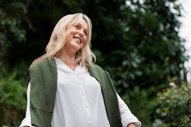 Medium shot smiley woman in nature