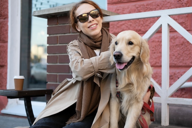 Free Photo medium shot smiley woman petting dog