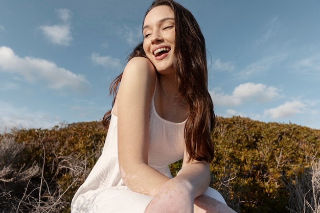 Medium shot smiley woman posing outside