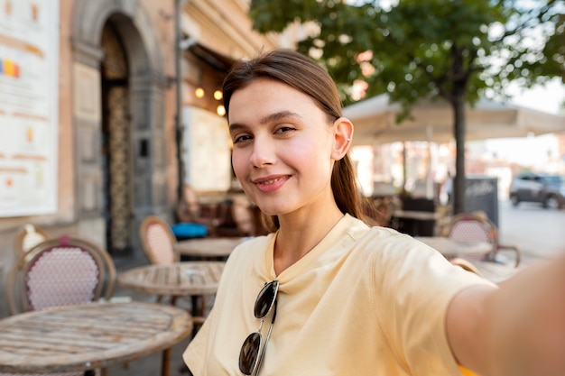 Medium shot smiley woman posing outside