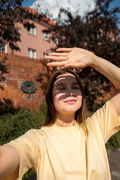 Medium shot smiley woman posing outside