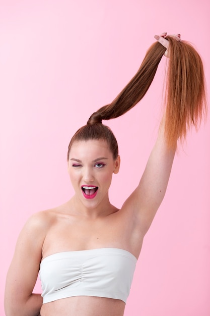 Free photo medium shot smiley woman posing with hair up