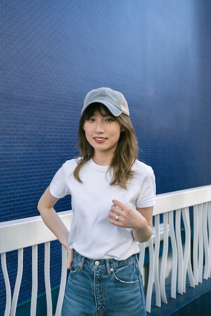 Free Photo medium shot smiley woman posing with trucker ha