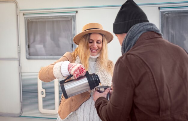 Medium shot smiley woman pouring coffee